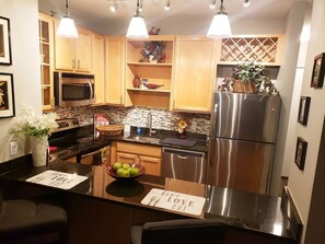 Full kitchen with utensils to cook or have food delivered. 