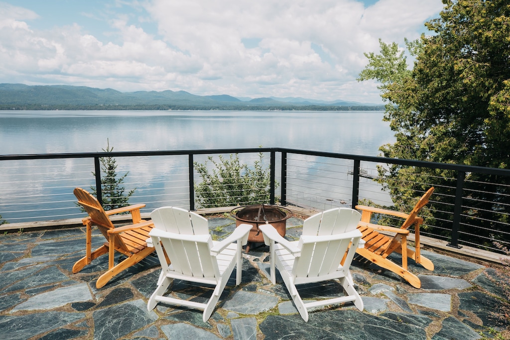 Outdoor Patio with portable firepit and several chairs around it from a second story balcony on Lake Champlain, Vermont.