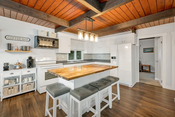 New butcher block island with comfortable stools; new fridge, stove & dishwasher