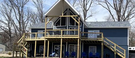 View of cabin from the lake. All new deck and covered deck in 2024.
 