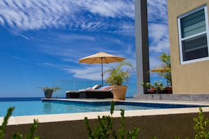 Pool and pool deck facing ocean.