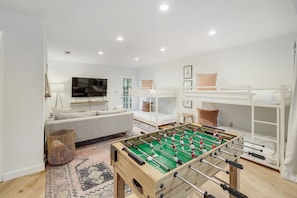 3rd bedroom is a Game Room with 4 twin beds, 65" TV, video games + foosball