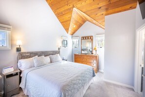 Located on the Upper Level is the Primary Suite  Vaulted Ceilings, HDTV and En Suite Bathroom– It is A Perfect Retreat