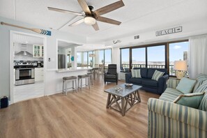 Living Room Looking into Kitchen & Sliders to Balcony