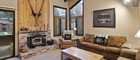 Living Room with a wood buring stove, access to deck