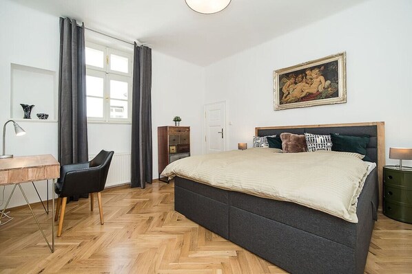 Spacious, elegant bedroom with workspace