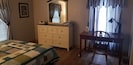 Master bedroom showing dresser and work desk