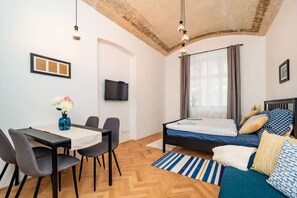 Bedroom with dining area TV and sofa
