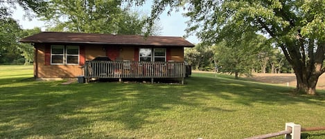 Front view of the house looking north. The house has a big yard.