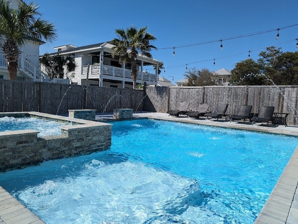 An amazing salt-water pool spa with waterfalls, deck jets, bubblers, & sun shelf