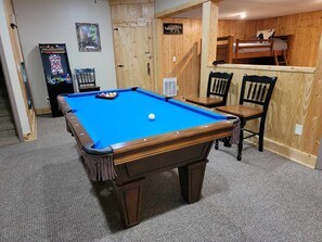 Pool Table and Arcade in walk out basement with bunk room.