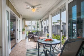 You have a large sunroom with lots of choices.  Close/open curtains, close/open sliders w/screens, close/open French doors to living room.