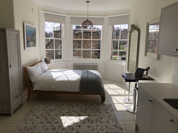 Bright and modern guest suite, featuring a large bay window.