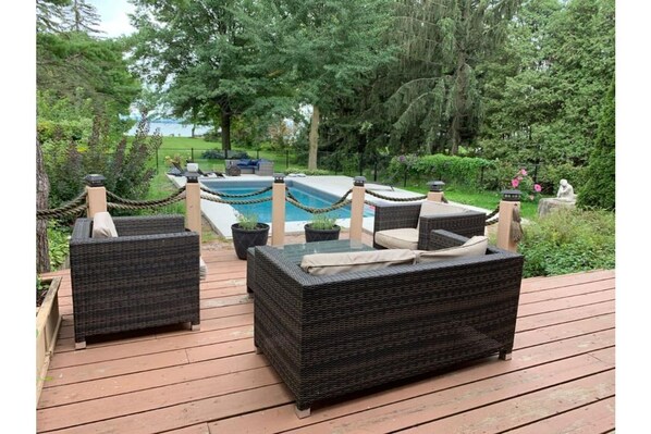 Deck overlooking the pool with views of the river. 