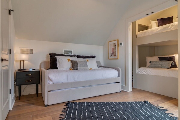 Our third floor loft bedroom offers rooftop deck access, ideal for your entire group!