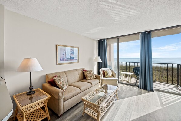 The ocean front living room is well-appointed with comfortable furnishings.