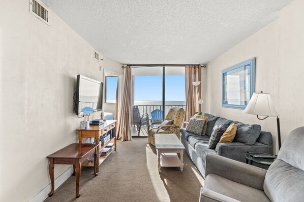 The ocean front living room is well-appointed with comfortable furnishings.