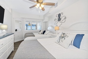 - Drift into comfort in a charming bedroom with soft linens & ocean inspired decor - Two cozy queen size beds make this space perfect for families or friends to unwind together - Sleep peacefully & wake up refreshed, ready for another beach day ahead