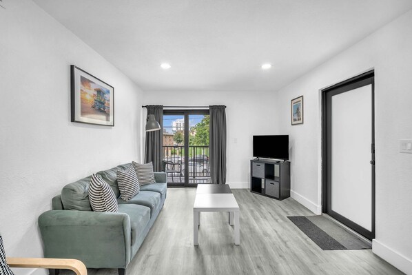 Take a break in the airy living space, where you'll find a comfortable sofa perfect for unwinding or enjoying entertainment on the streaming-ready TV.