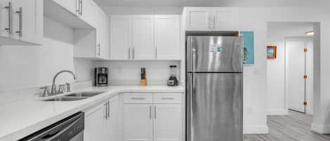 The kitchen boasts ample space, essential appliances, and abundant storage options.