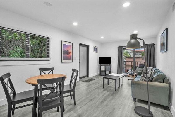 Serene and inviting living area with cushy seats, a coffee table, and seamless access to your own balcony