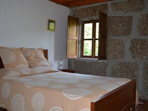 1st bedroom includes 1 double bed, 2 bed side tables and a big closet.
