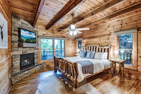 Retreat to the spacious master bedroom on the main floor featuring a gas fireplace, large Roku TV, and ensuite bathroom.