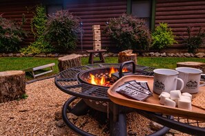 Unwind by the fire pit, indulge in s'mores, and let your family have fun playing corn hole in the refreshing outdoor atmosphere.