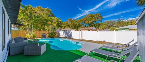 Beautiful fully fenced backyard with magnificent heated pool with seating area.