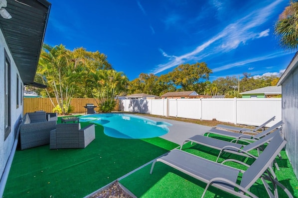 Beautiful fully fenced backyard with magnificent heated pool with seating area.