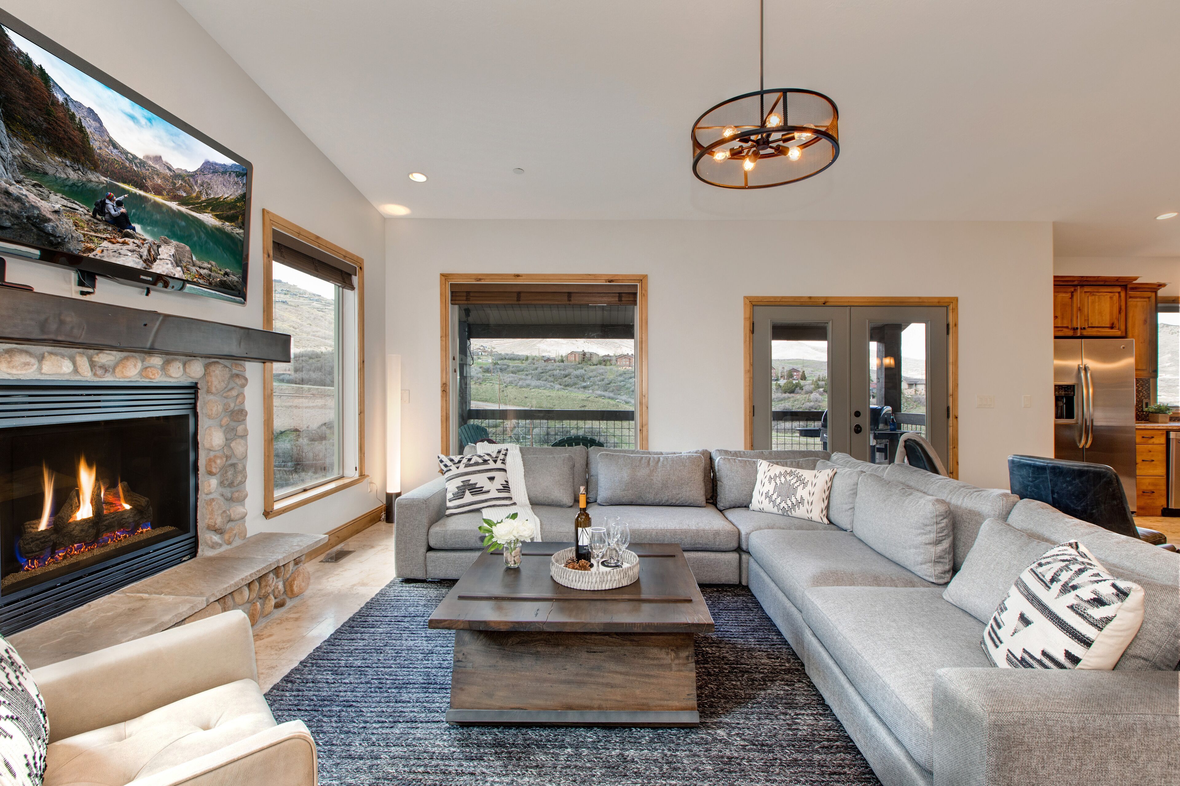 Comfortable Living Room with a New Sectional Sofa, 55" HD TV with Dish Satellite, and a Cozy Gas Fireplace