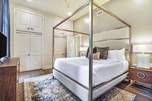 Spacious master bedroom 2 with king-size bed, ensuite bathroom, and designer built-in closets. Features nightstands, hangers, luggage racks, alarm clock, white noise machine, and a 43'' Samsung Smart 4K TV with streaming and DIRECTV Entertainment.