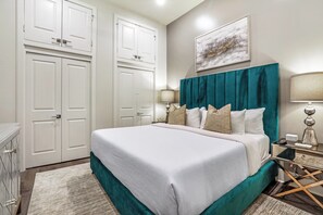 Spacious guest bedroom 2 with a king-size bed and designer built-in closet. Equipped with nightstands, lamps, hangers, luggage rack, alarm clock, white noise machine, and a 50'' Samsung Smart 4K TV with streaming and DIRECTV Entertainment.
