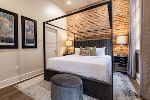 Side 2: Spacious primary bedroom with a king bed, ensuite bath, and designer built-in closets. Includes nightstands, lamps, alarm clock, white noise machine, and a 50'' Samsung Smart 4K TV with streaming and DIRECTV Entertainment.