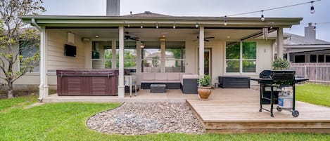 Gorgeous fully fenced backyard with over-sized HOT TUB, grill and seating space.