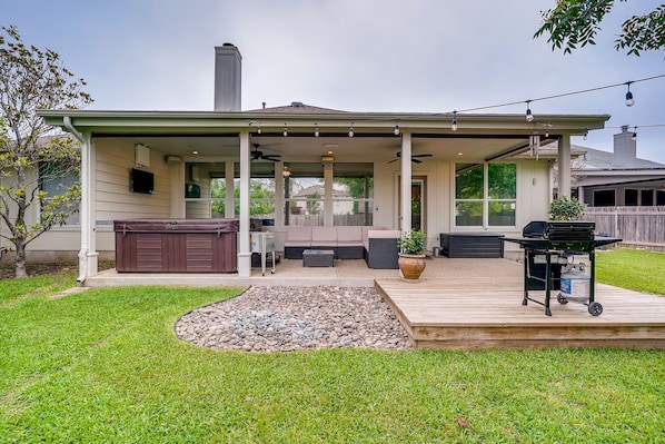 Gorgeous fully fenced backyard with over-sized HOT TUB, grill and seating space.