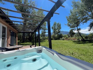 Summer hot tub view of the yard and mountains