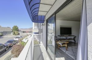 Panoramic sliding door opens to a peek-a-boo ocean view and quiet neighborhood. The condo is walkable to beach access and nearby restaurants.