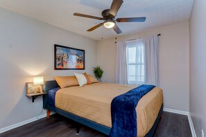 Luxury Simmons bedding and wood bedside lamp in bedroom #1 of three.
