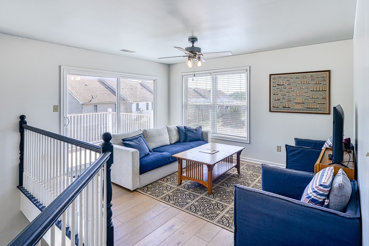Three-story lakefront home w/ covered boat slip, and tennis/pickleball access