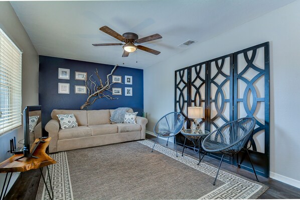 Your living room with real driftwood on the wall, surrounded with photographs.