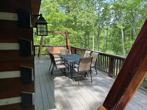 outdoor dining with two swings on the deck