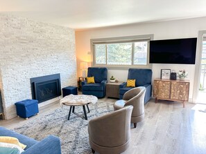 Living room with gas fireplace, two rocker/recliners and TV