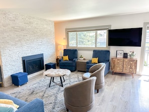 Living room with gas fireplace, two rocker/recliners and TV