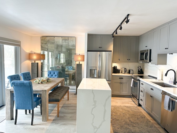 Fully stocked kitchen and dining area with Restoration Hardware furnishings 