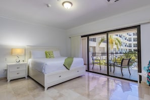 Bedroom with a nightstand, table lamp, and air conditioning.