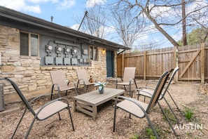 Private fenced in backyard with seating