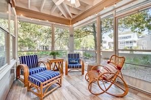 Screened in porch overlooking pool and courtyard