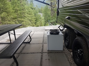 Covered outdoor eating area with drinks fridge and electric grill