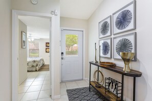 foyer and front door, with primary bedroom to the left.